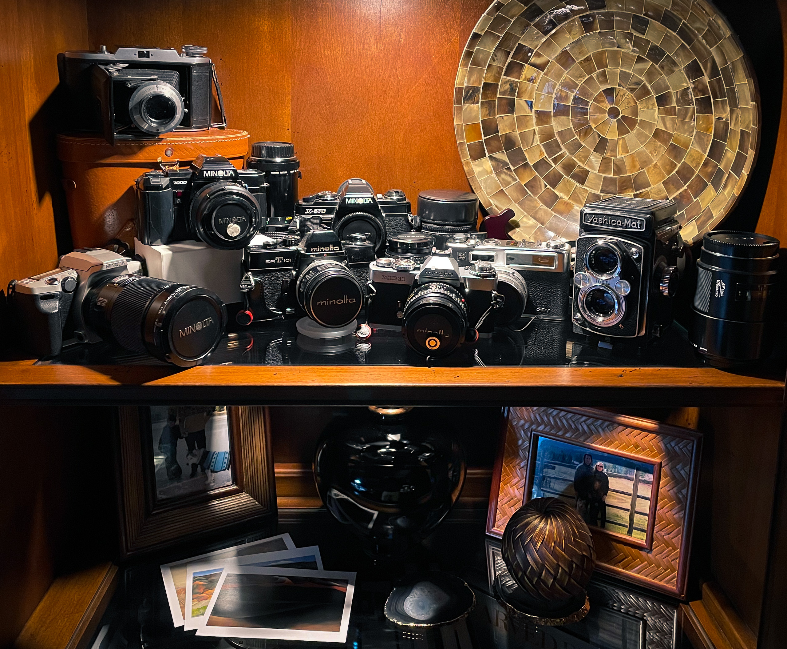 Collection of film cameras including medium format Yashica-Mat and Voigtlander Bessa I, Electro 35 rangefinder, and multiple generations of Minolta SLRs.